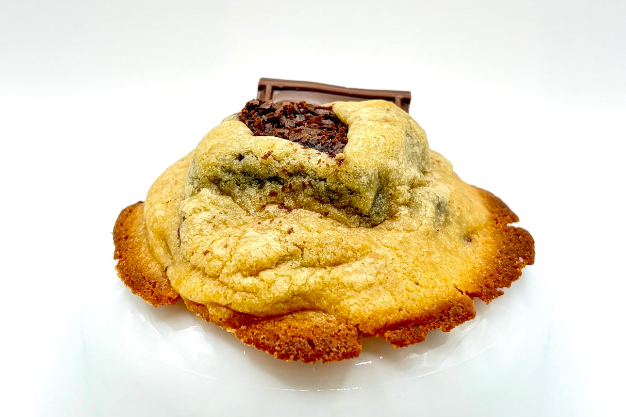 Chocolate chip cookie with a brownie filling on a white background