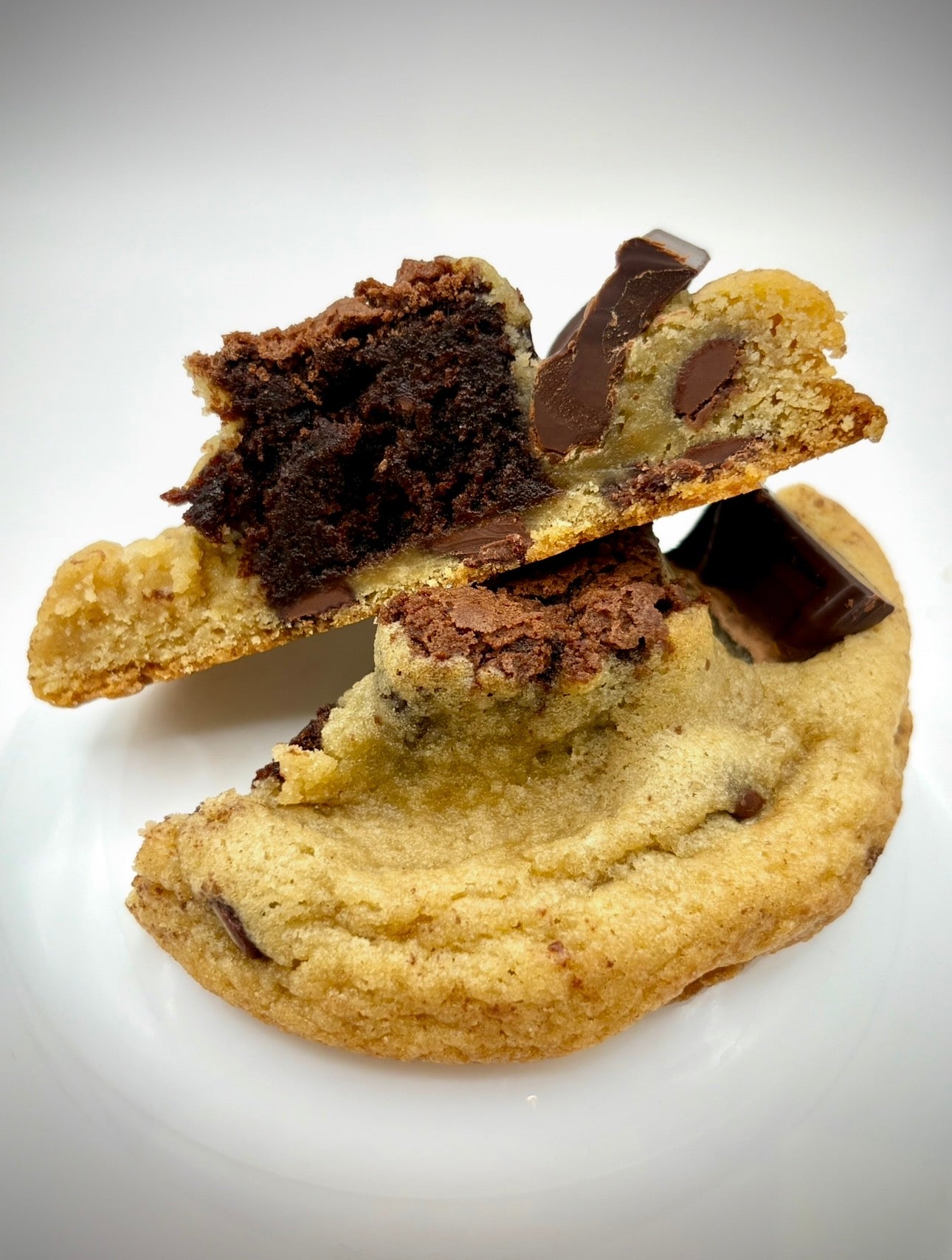 Chocolate chip cookie with a brownie center white background