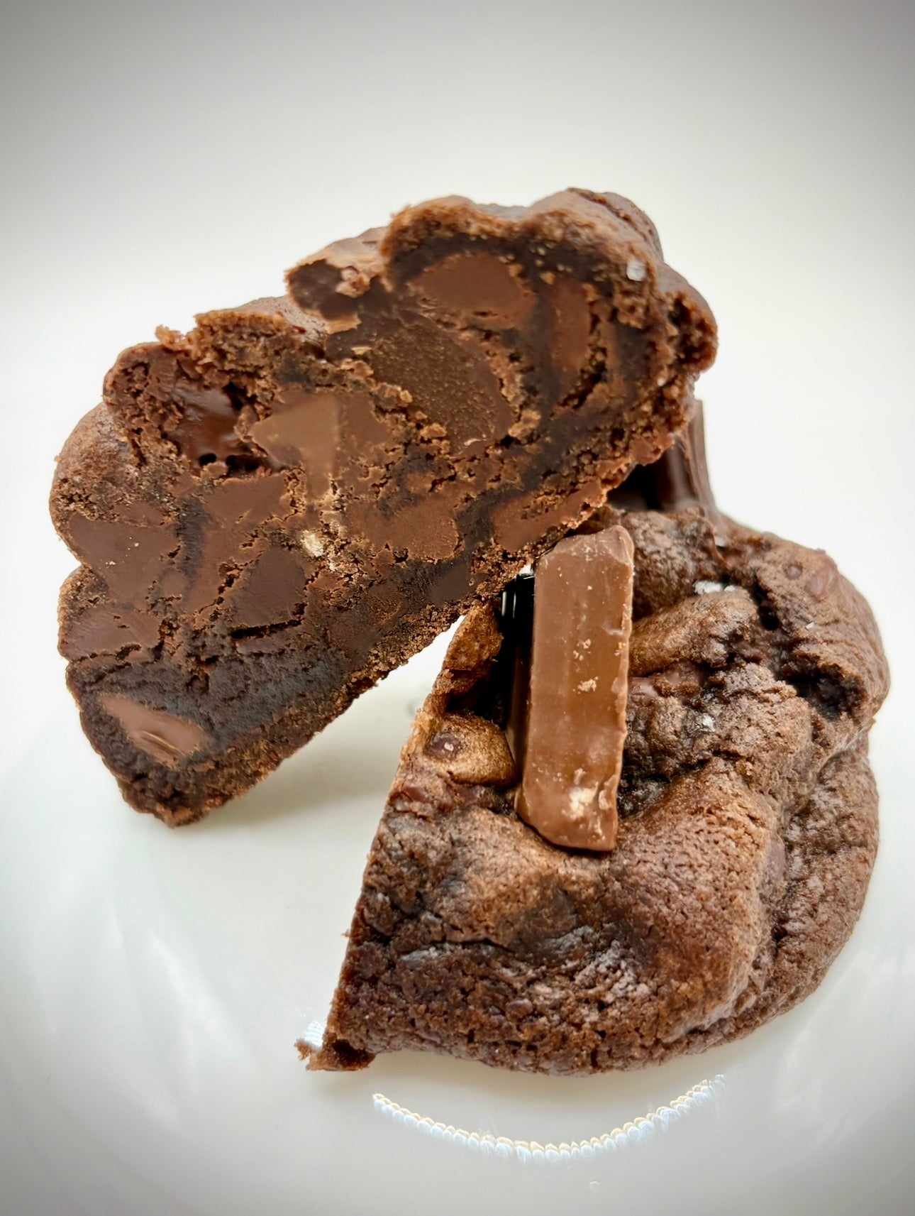 Chocolate cookie with a visible chocolate chip on a white background