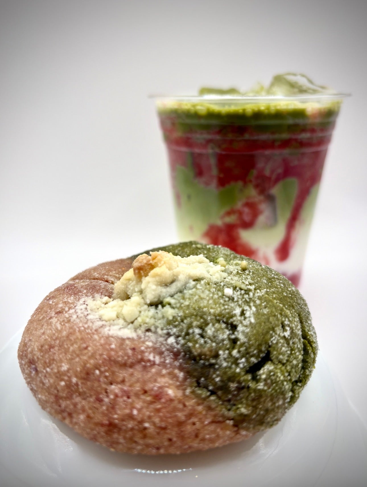 matcha strawberry cookie in front of colorful drink
