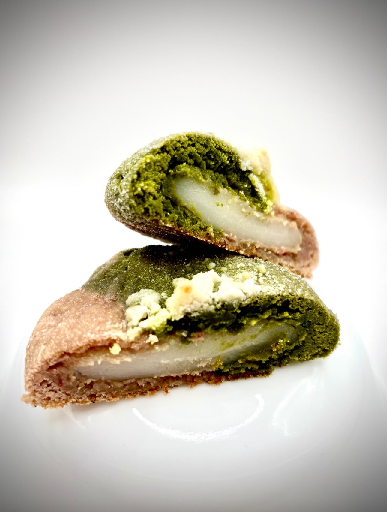 Green tea match and strawberry cookie with mochi center filling on white background