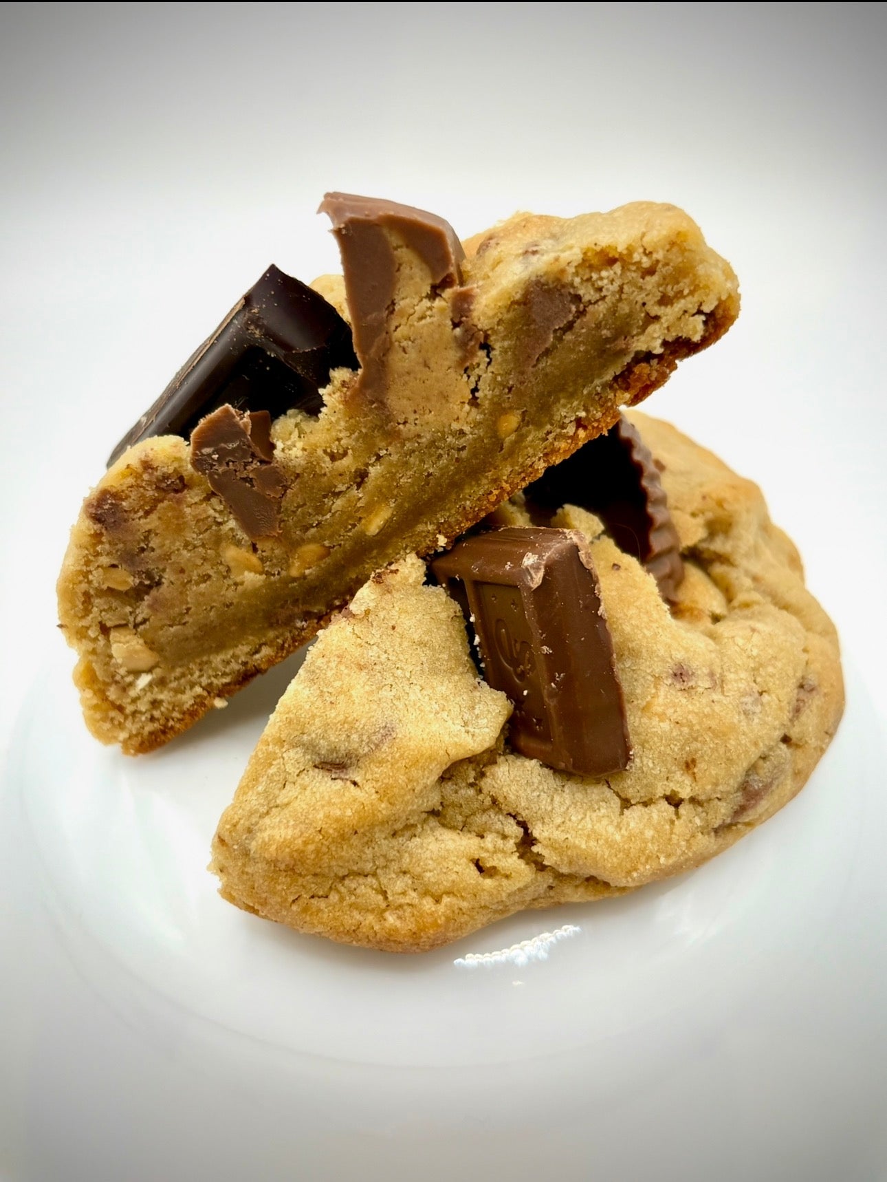 Peanut butter cookie with chocolate chunks on a white background